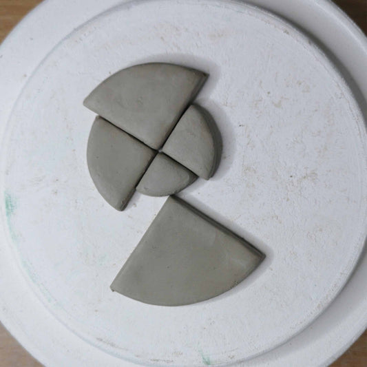 Five different sized quarter circles cut from stoneware clay.