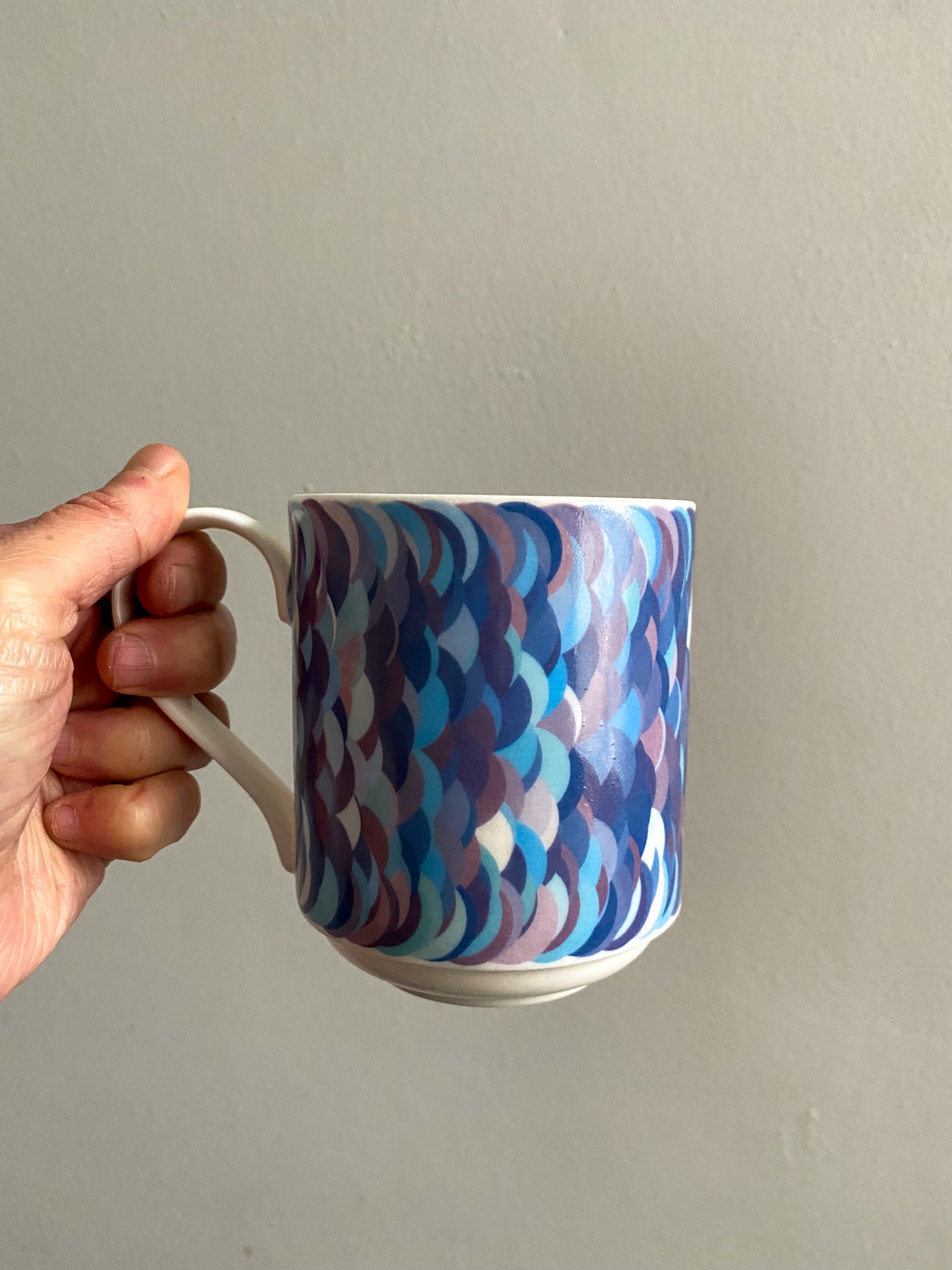 Bone china mug with purple/blue pattern of mathematically plotted circles